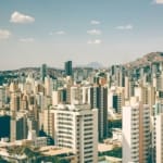 A panoramic view of a bustling city skyline showcasing modern architecture and urban landscape.
