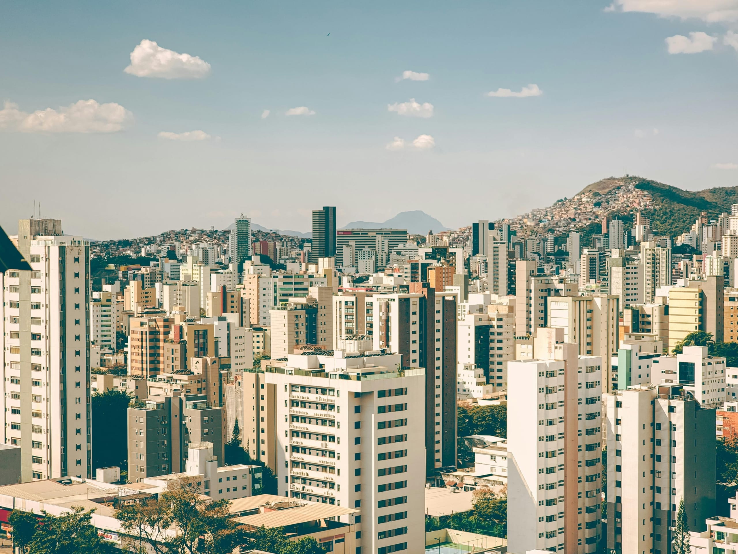 A panoramic view of a bustling city skyline showcasing modern architecture and urban landscape.