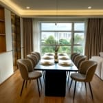 Elegant dining room with cityscape view, featuring table settings for eight.